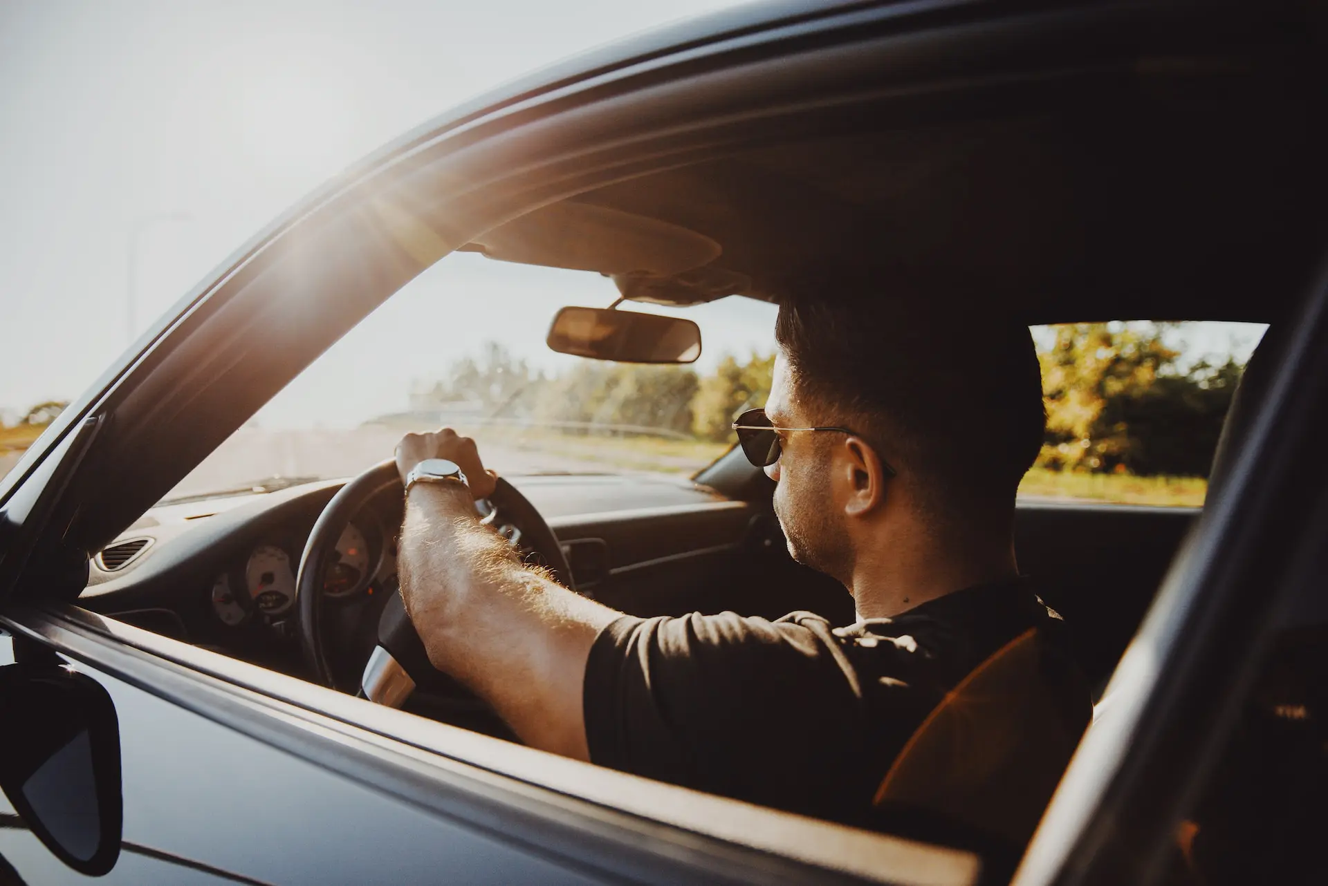 man driving with window down