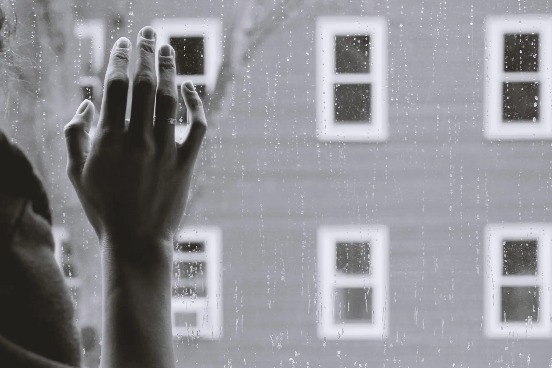 sad person standing in a window - what are non-economic damages