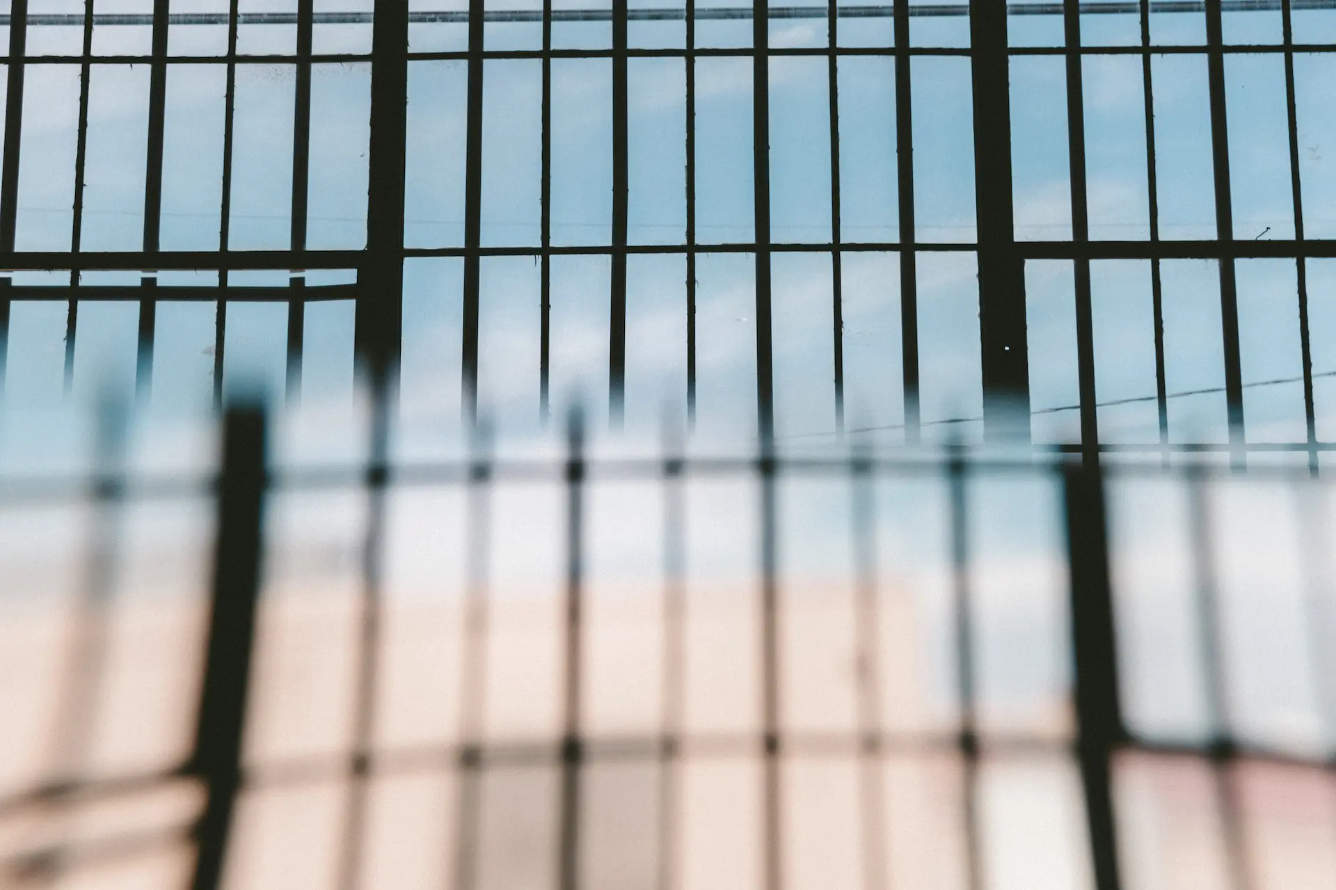 bars across sky - jail vs. prison