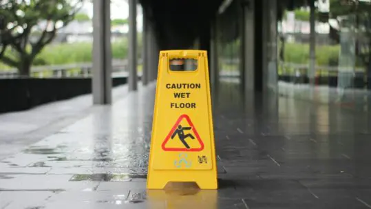 wet floor sign over wet ground