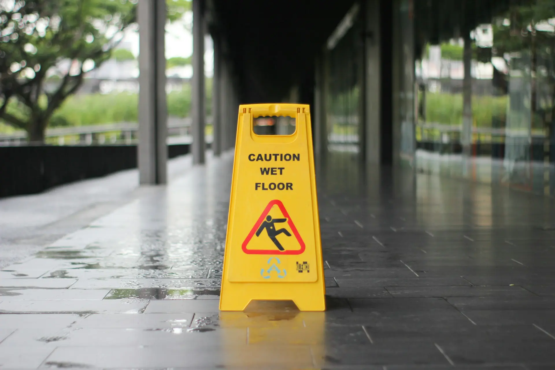 wet floor sign over wet ground