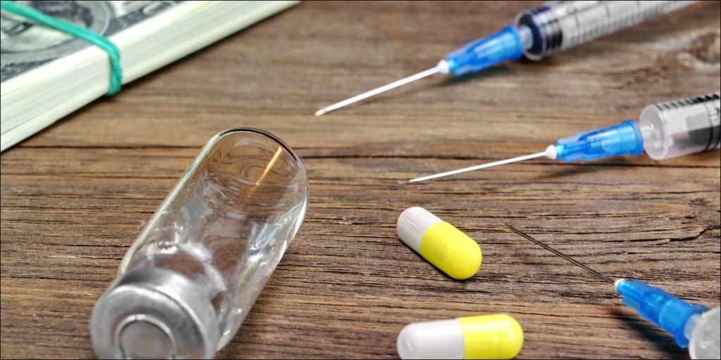 drug capsules next to syringes
