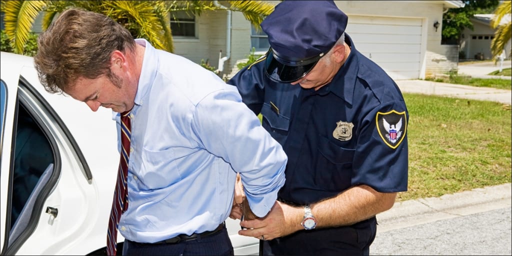 Business man being arrested