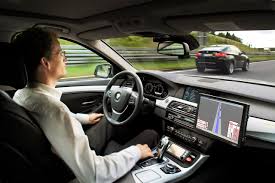 man in a self driving car on the road