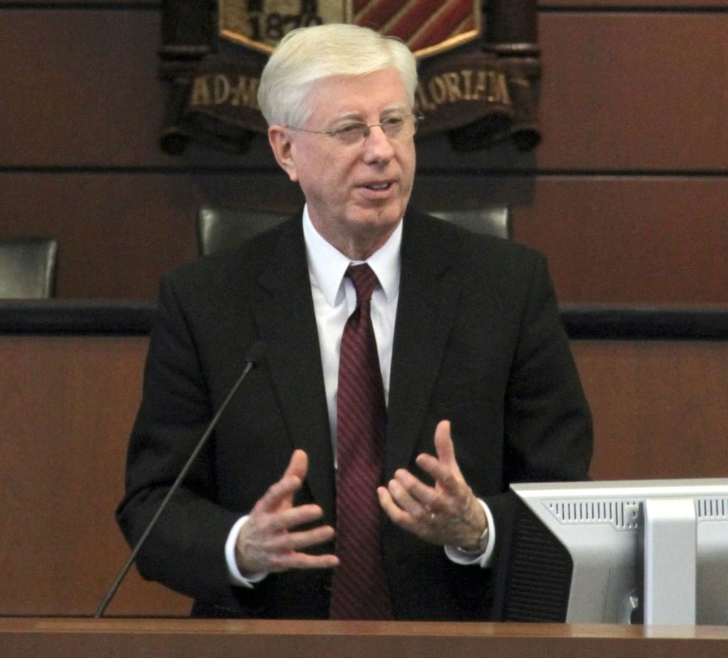 Attorney General Tom J Miller speaking at a hearing