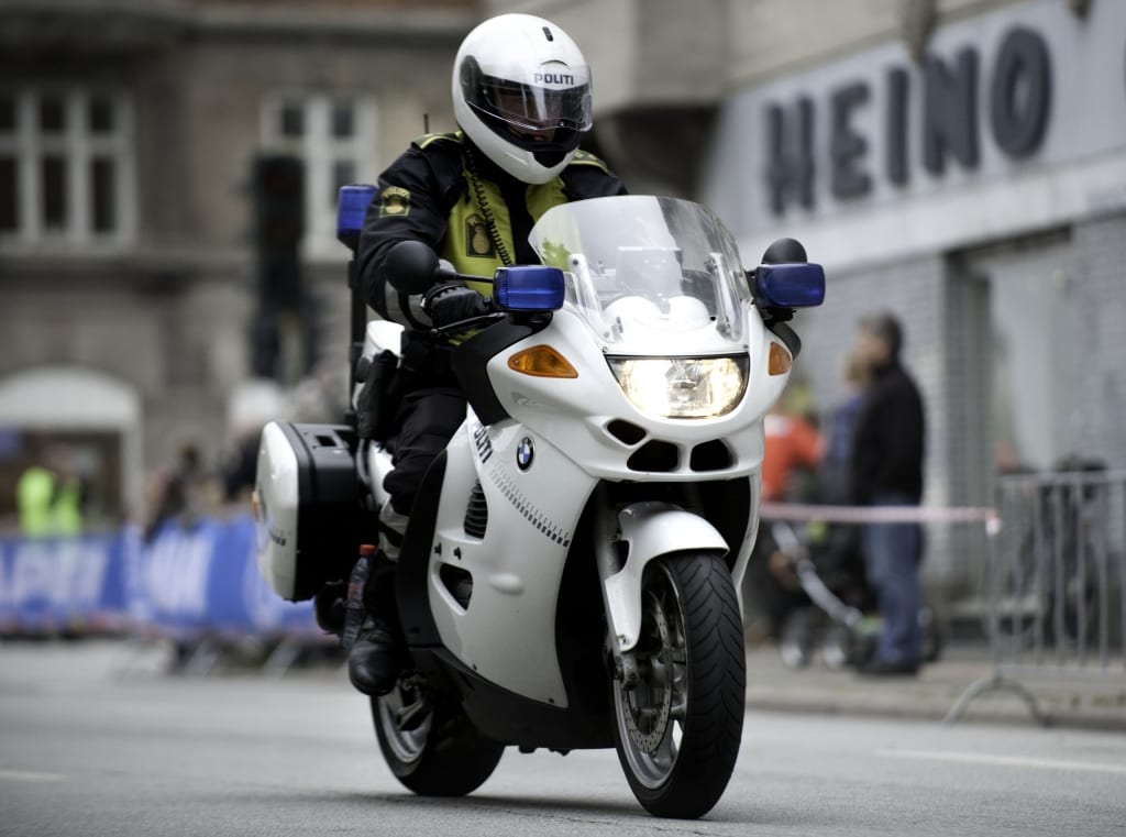 Danish police safely driving a motorcycle