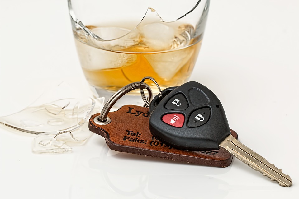 Glass of whiskey next to car keys