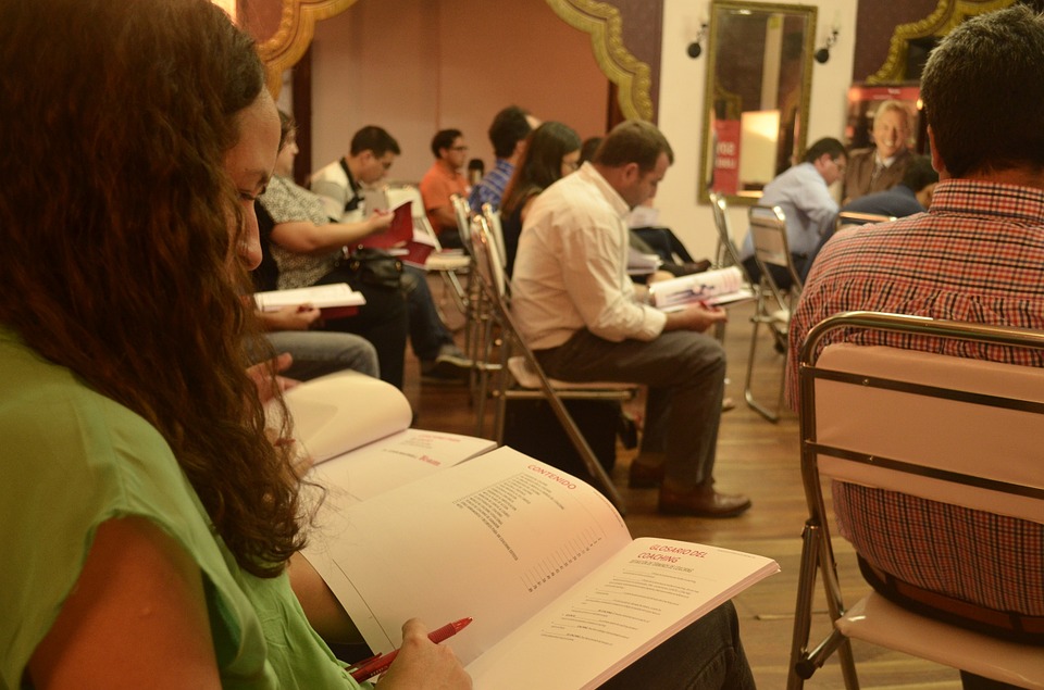 students looking at workbooks