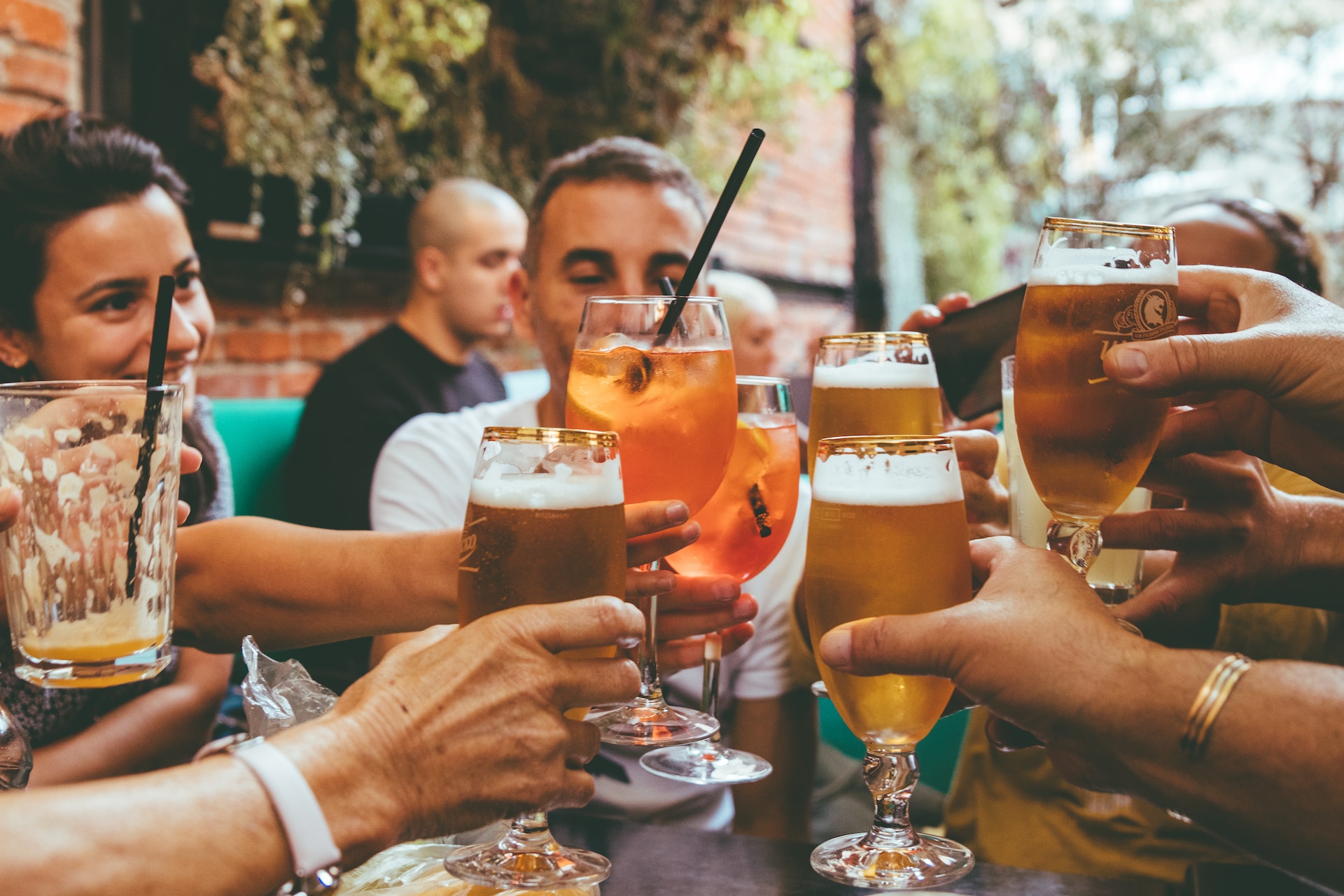 friends drinking at a restaurant with glasses lifted