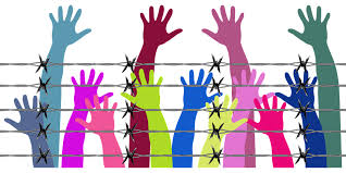 hands reaching over fence