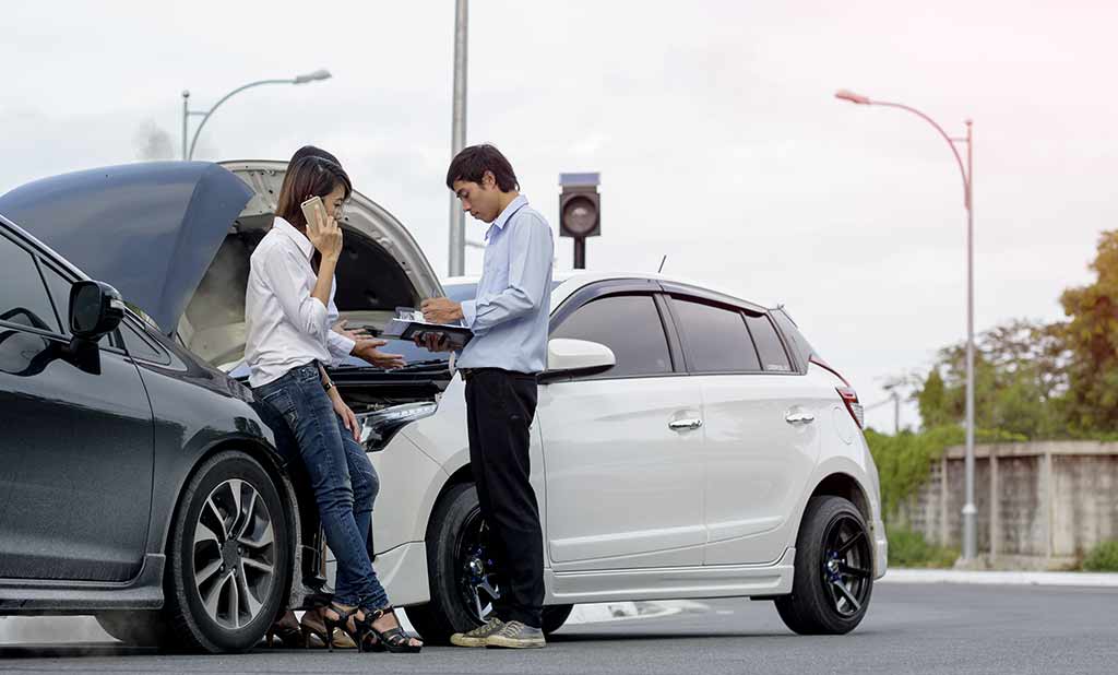 Two people at a car accident