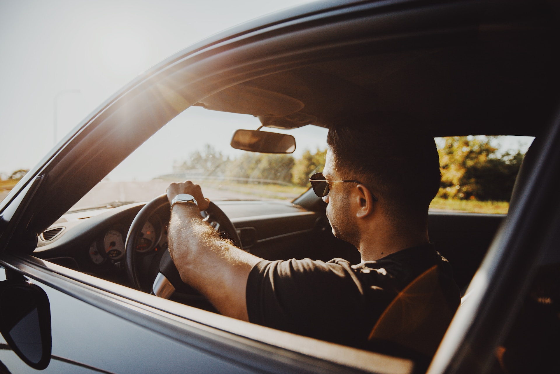 man driving with window down