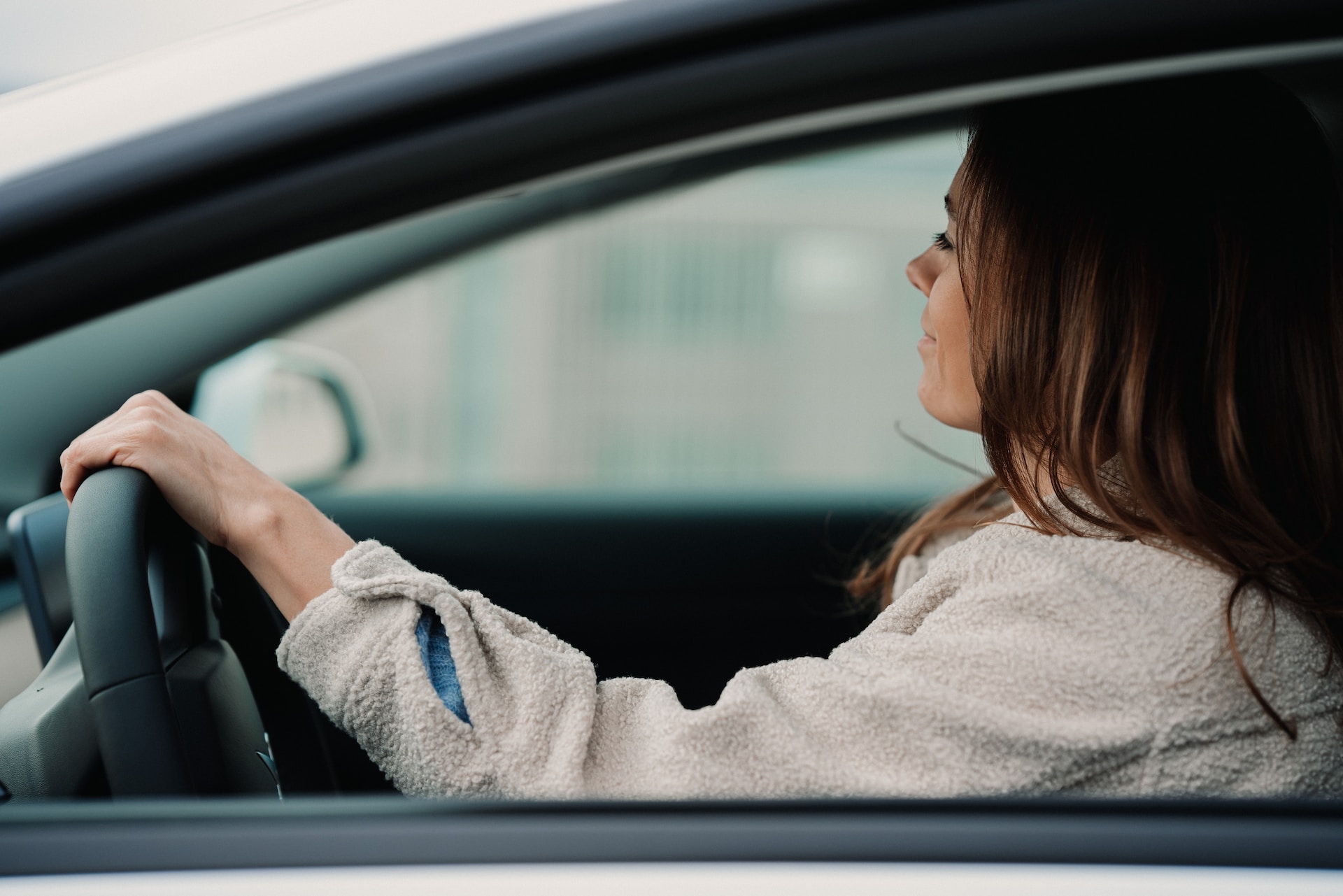 woman driving and smiling